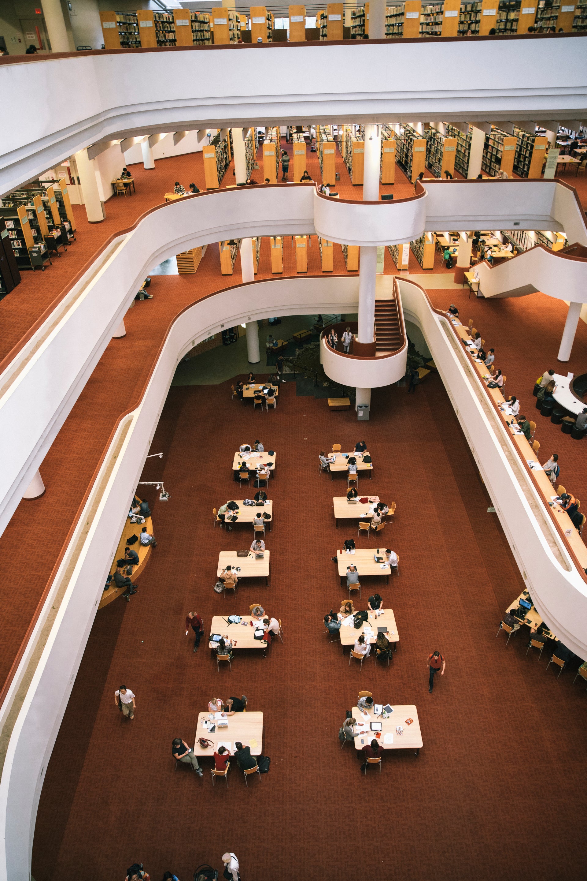 Aerial view of a modern university library study space with students studying together, ideal for TOEIC preparation.